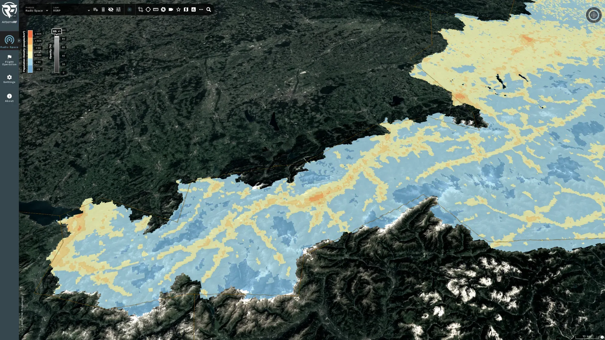 Oblique 3D view of an alpine valley network with a blue-to-red population-density heatmap draped over the terrain and a people-per-square-kilometre legend in the AirborneRF portal